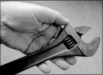 Hand holding adjustable spanner GX7 P1140620 Mono.JPG