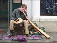 Busker with drum and long horn London E-20P P2100002.jpg