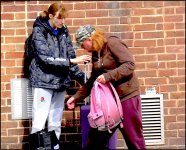 Two women by brick wall Exeter FZ82 P1010559.jpg